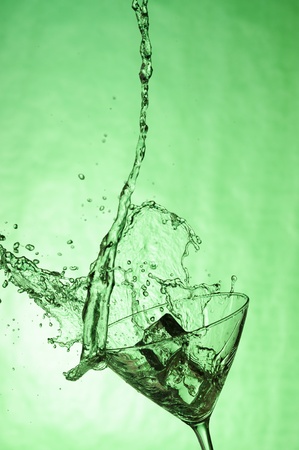 Martiniglass with stream fresh drink. Splashing cocktailの写真素材