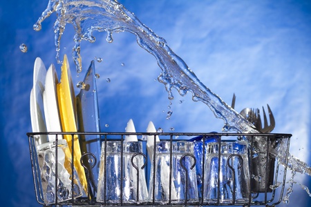 Washing plates in the dishwasher. Inside a dishwasherの写真素材