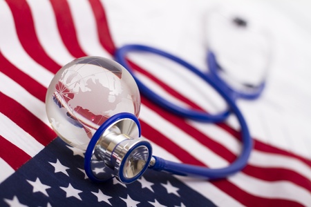 Stethoscope and globe on a USA flagの写真素材