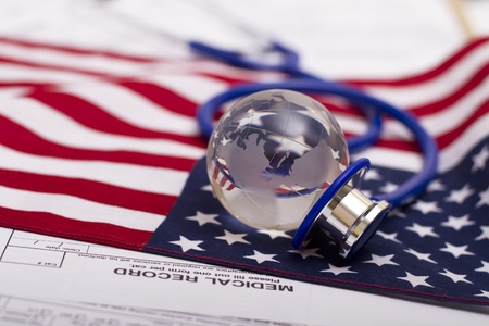 Stethoscope and globe on a USA flagの写真素材
