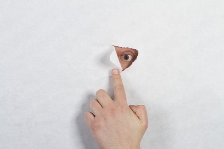 Peeking through a holeの写真素材