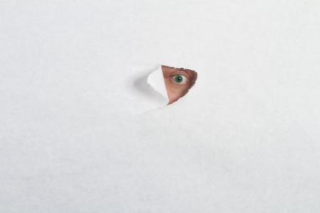 Peeking through a holeの写真素材