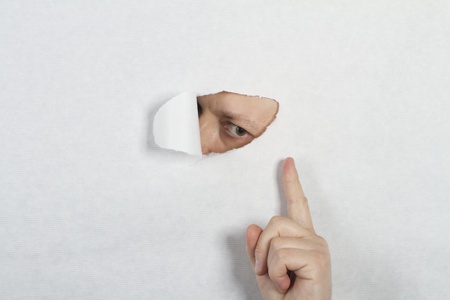 Peeking through a holeの写真素材