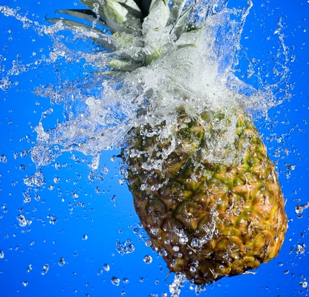 Pineapple with splashing water on blue background
の写真素材