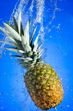 Pineapple with splashing water on blue background
の写真素材