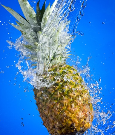 Pineapple with splashing water on blue background
の写真素材
