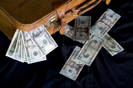 Cash ,dollar sticking out of overfilled case
の写真素材