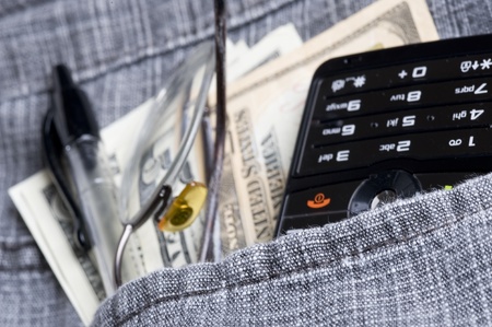 Cell phone in jeans pocket  and dollar
の写真素材