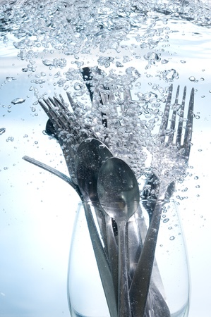 Washing kitchen ware in clear water on bubbles background
の写真素材