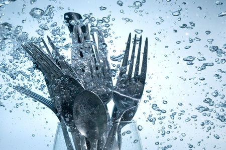 Washing kitchen ware in clear water on bubbles background
の写真素材