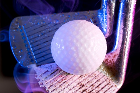 Old golf clubs with  ball on black backgroundの写真素材