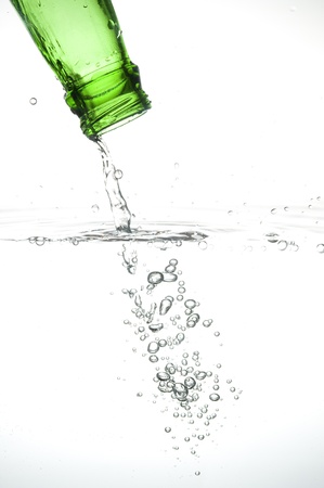 Green bottle with creative splashing blue water
の写真素材