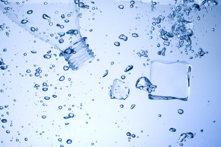 Mineral water with ice. Creative splashing blue water