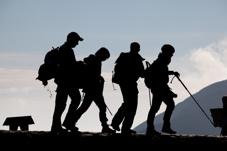 Group of young people trekking in the mountainsの写真素材