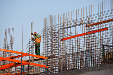 Worker prepearing steel rods to concrete