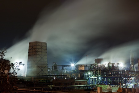 Steaming chemical facilities with pipes and cooling towerのeditorial素材