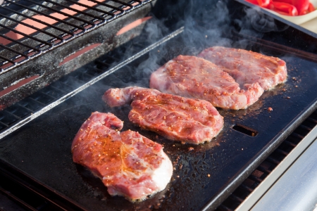 Meat  sizzling on the BBQの写真素材