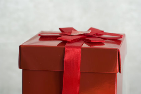 a gift in a red box with a red ribbon tooの写真素材