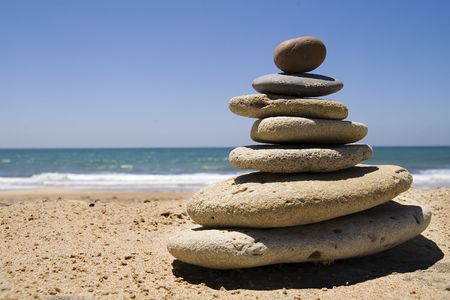 stones on the beach, forming a pyramid in balanceの写真素材