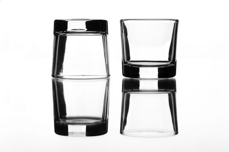 two small cups placed beside each other and reflected in a mirrorの写真素材