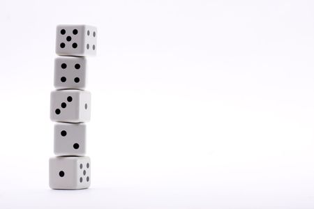 typical five dice put one above the other with a different numberingの写真素材