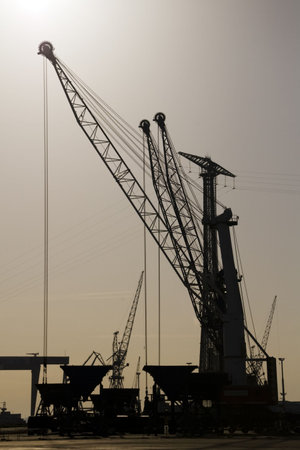 a port cranes working in the early morning hours
