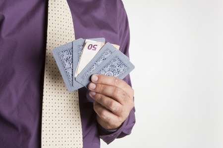 a man playing cards with a $ 50 ticket, symbolizing the betのeditorial素材