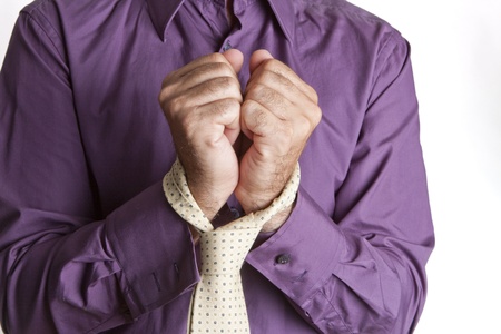 a man handcuffed to his tie for work pressureの写真素材
