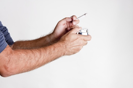a man firing a 10 euro bill like a cigaretteの写真素材