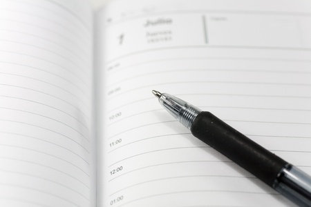 a pen over a diary to recordの写真素材