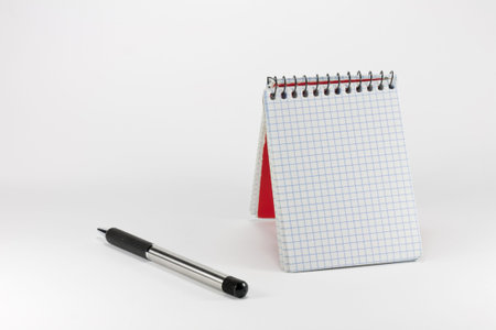 notepad with a pen on top tables