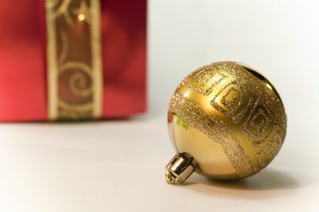 Christmas ball and a gift behind herの写真素材