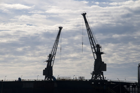 two huge cranes on top of a dam