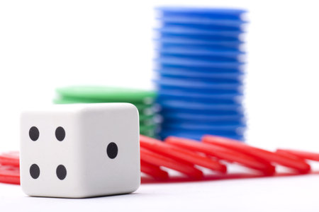 dice surrounded by colored tokens won in a casino