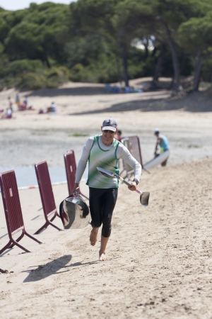 PUERTO REAL, SPAIN - JUNE 09: An unidentified canoeist arrives on shore during the veterans category in the championship canoe race Andalucia on June 09, 2012 in Puerto Real, Cadiz, Spain. のeditorial素材