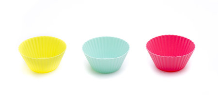Stack of a variety of colorful cupcake liners in pastel colorsの写真素材