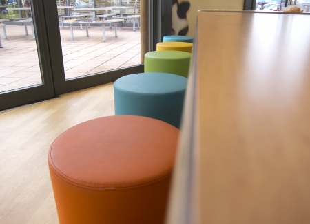 different colored chairs in a modern restaurantの写真素材