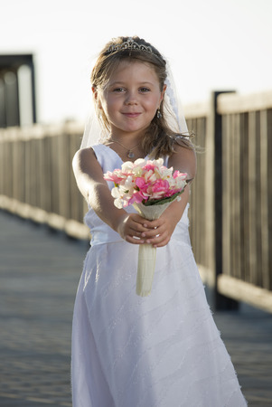 a girl in a wedding dress on the beachの写真素材