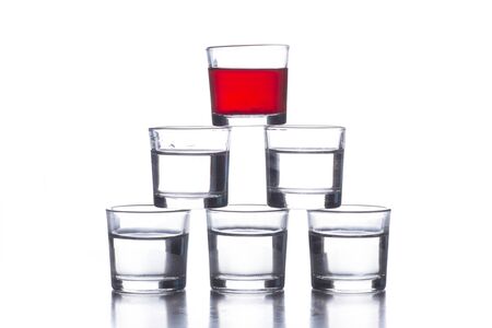several shot glasses with different drinks, which combined represent the flag of a countryの写真素材