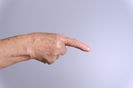 close up of elderly hand indicate something in distanceの写真素材