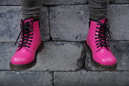 Nice pink alternative girl or woman Military skinhead shoes - sitting toughの写真素材