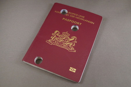 Unusable perforated damaged Dutch passport - Nederlands Paspoortの写真素材