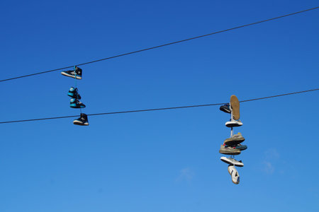 Shoes on wires - Shoe dangling, flinging or tossing