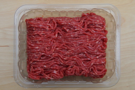 Raw Minced Meat In A Black Plastic Containerの写真素材