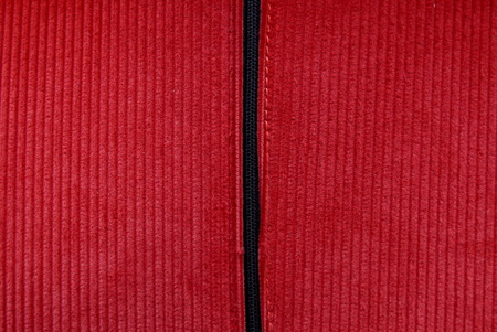 Closed black zip on red corduroy fabricの写真素材