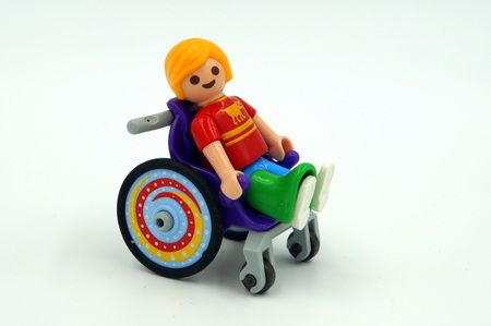 happy child with a broken leg sitting in a wheelchair.のeditorial素材