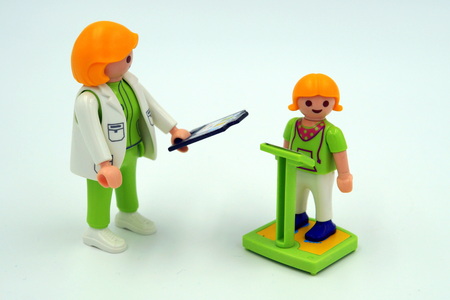 Pediatrician determining the weight a of child.のeditorial素材