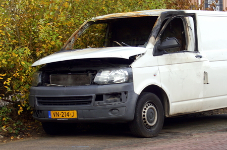 Naarden, the Netherlands - November 11, 2018: White burned out Volkswagen Transporter by the side of the road. Nobody in the vehicle.のeditorial素材