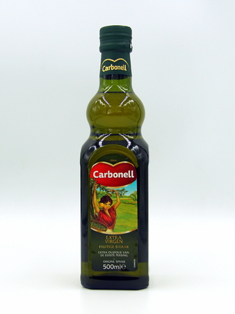 Amsterdam, the Netherlands - December 14, 2018: Green bottle of Carbonell Olive Oil against a white background.のeditorial素材