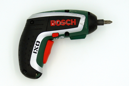 Amsterdam, the Netherlands - March 1, 2019: Used Bosch IXO electric screwdriver against a white background.のeditorial素材